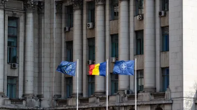 Bucharest, Romania - 6 April 2019: EU flag, Romanian flag and NATO flag wave in the wind in front of the Ministry of Internal Affairs in Bucharest, Romania.