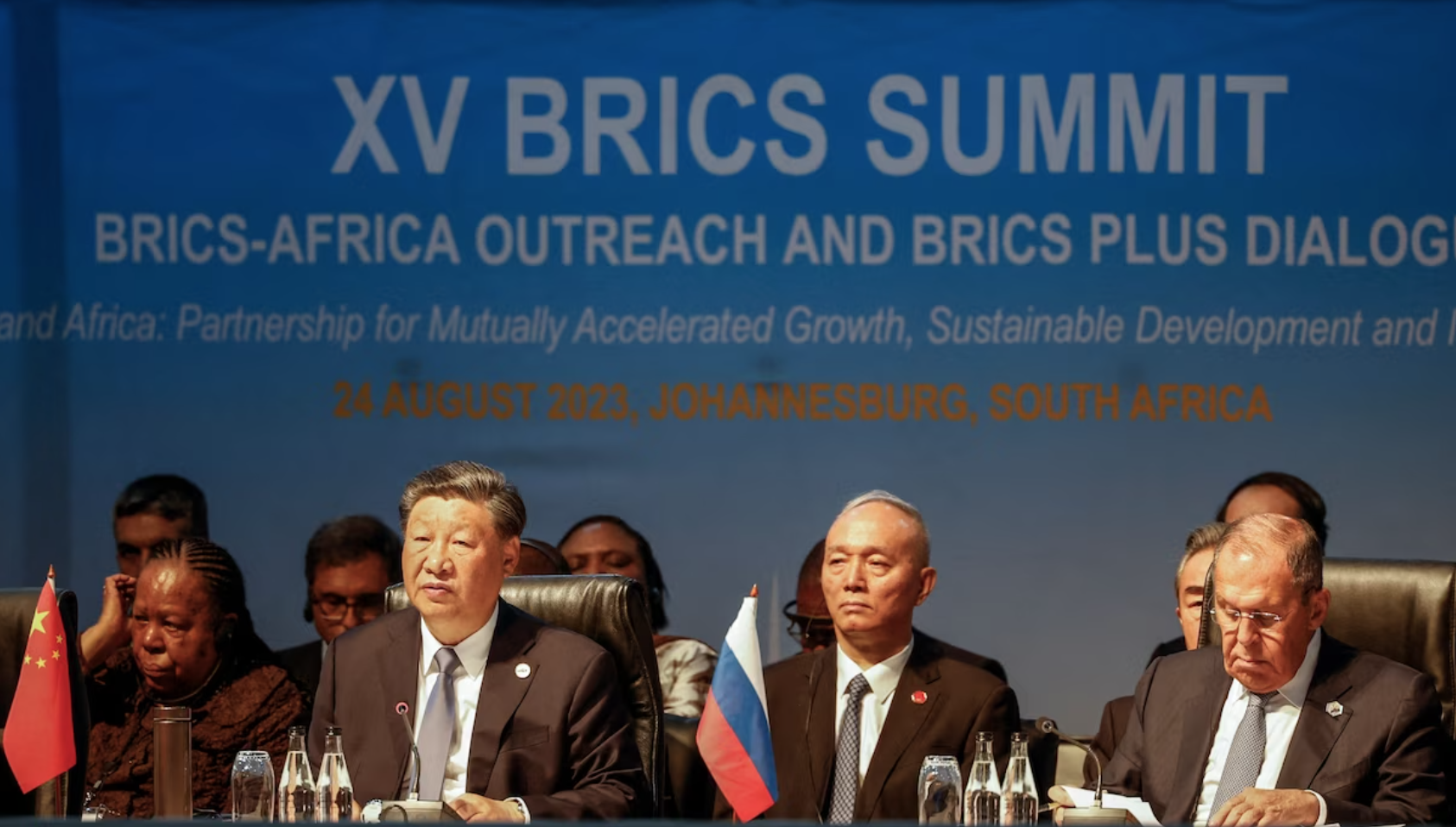 Chinese leader Xi Jinping, left, and Russian Foreign Minister Sergei Lavrov, right, attend the BRICS summit in Johannesburg