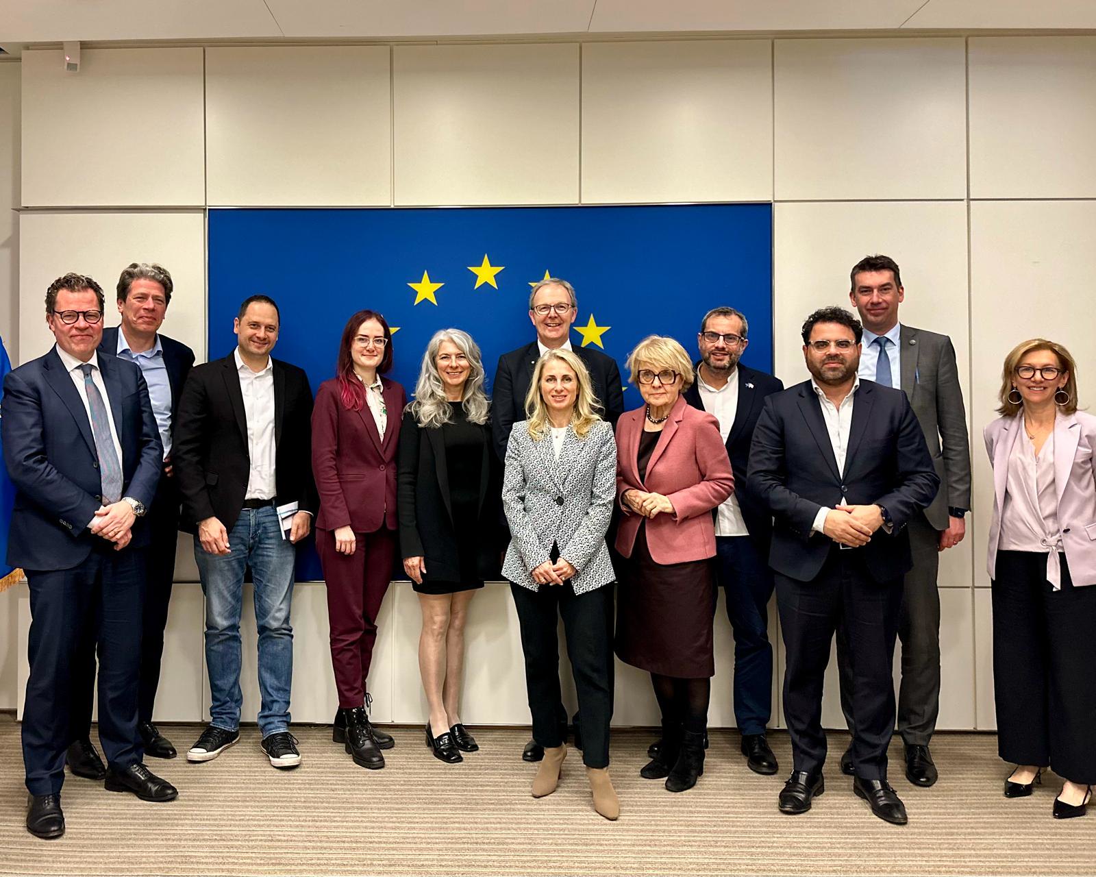 People standing in front of a EU flag