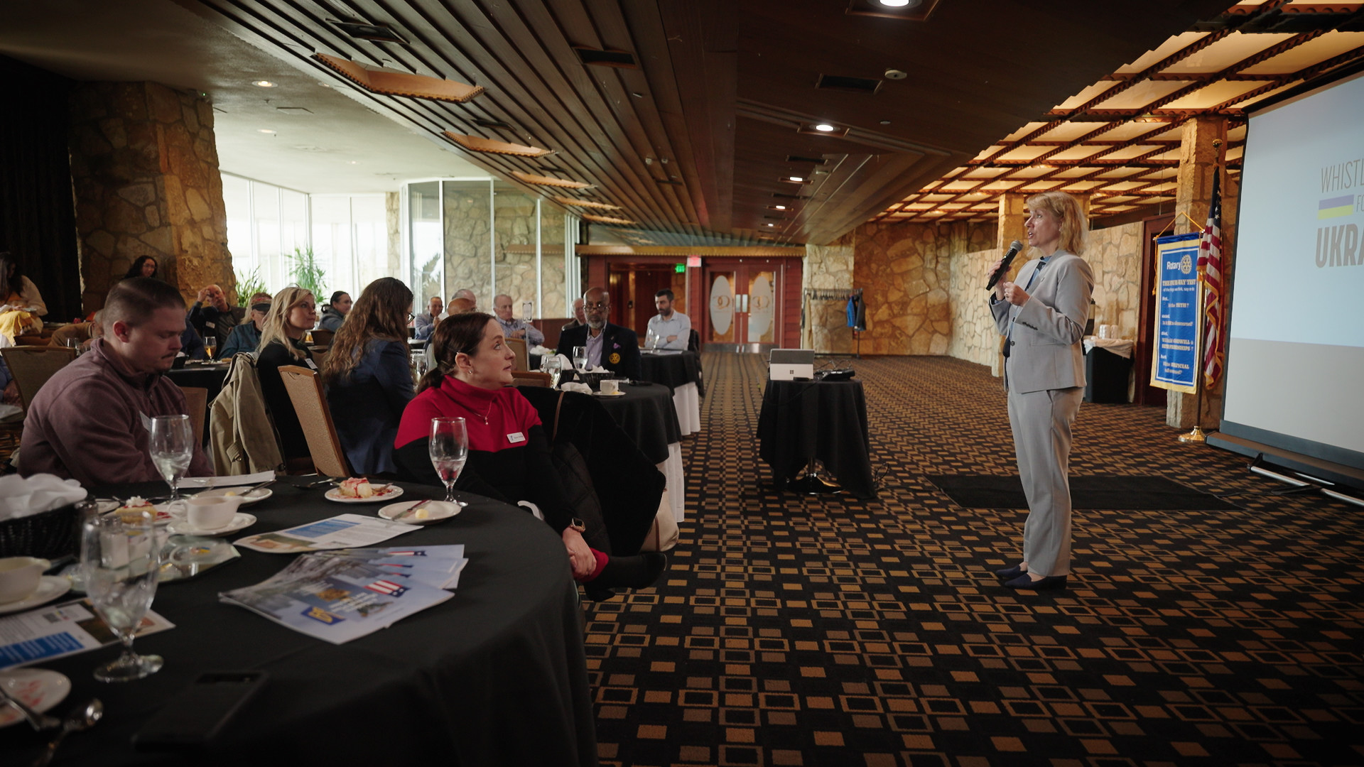 GMF President Heather Conley standing in front of seated people at a Rotary Club luncheon in a ballroom