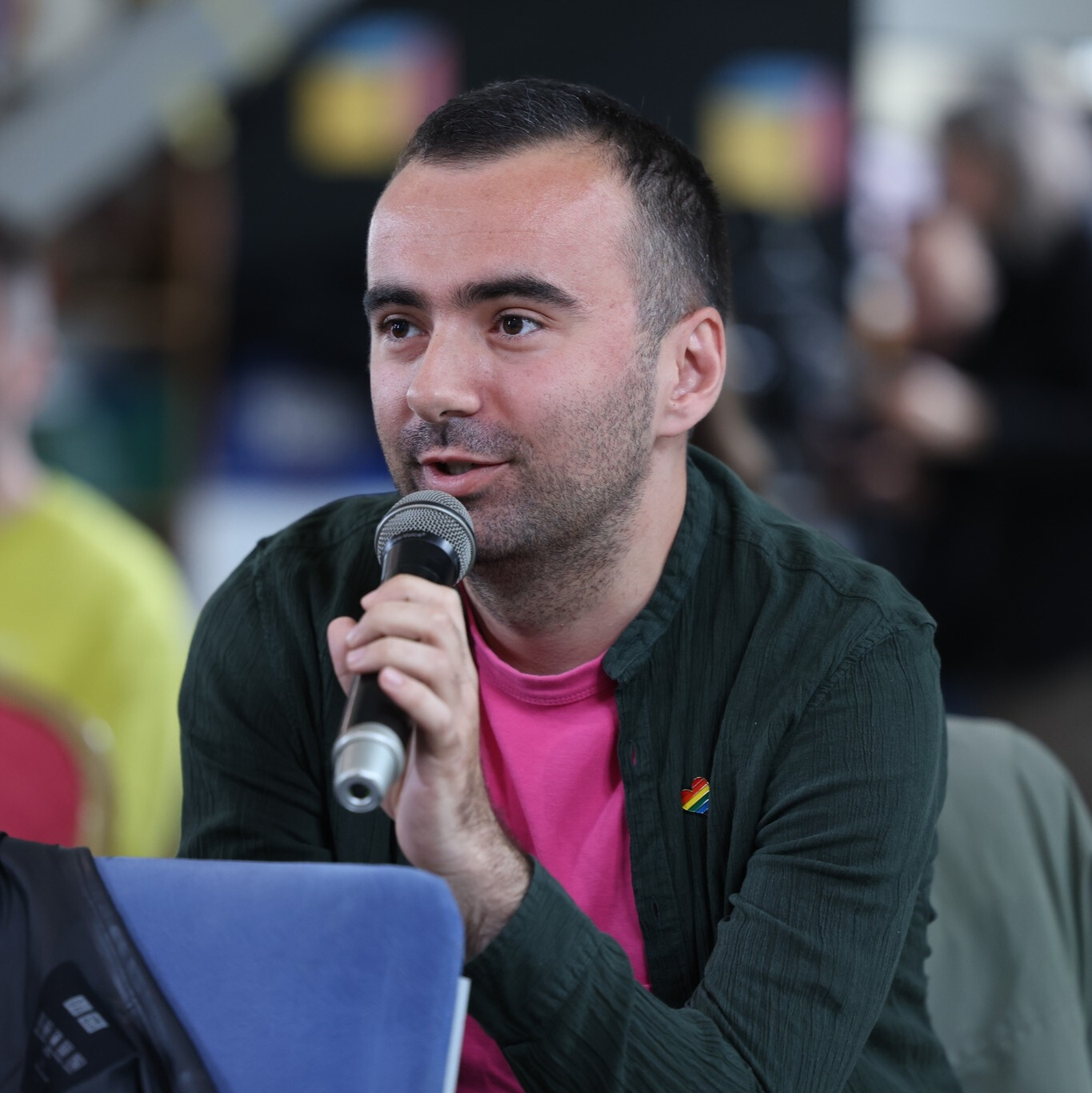 Man holding a microphone giving a speech 