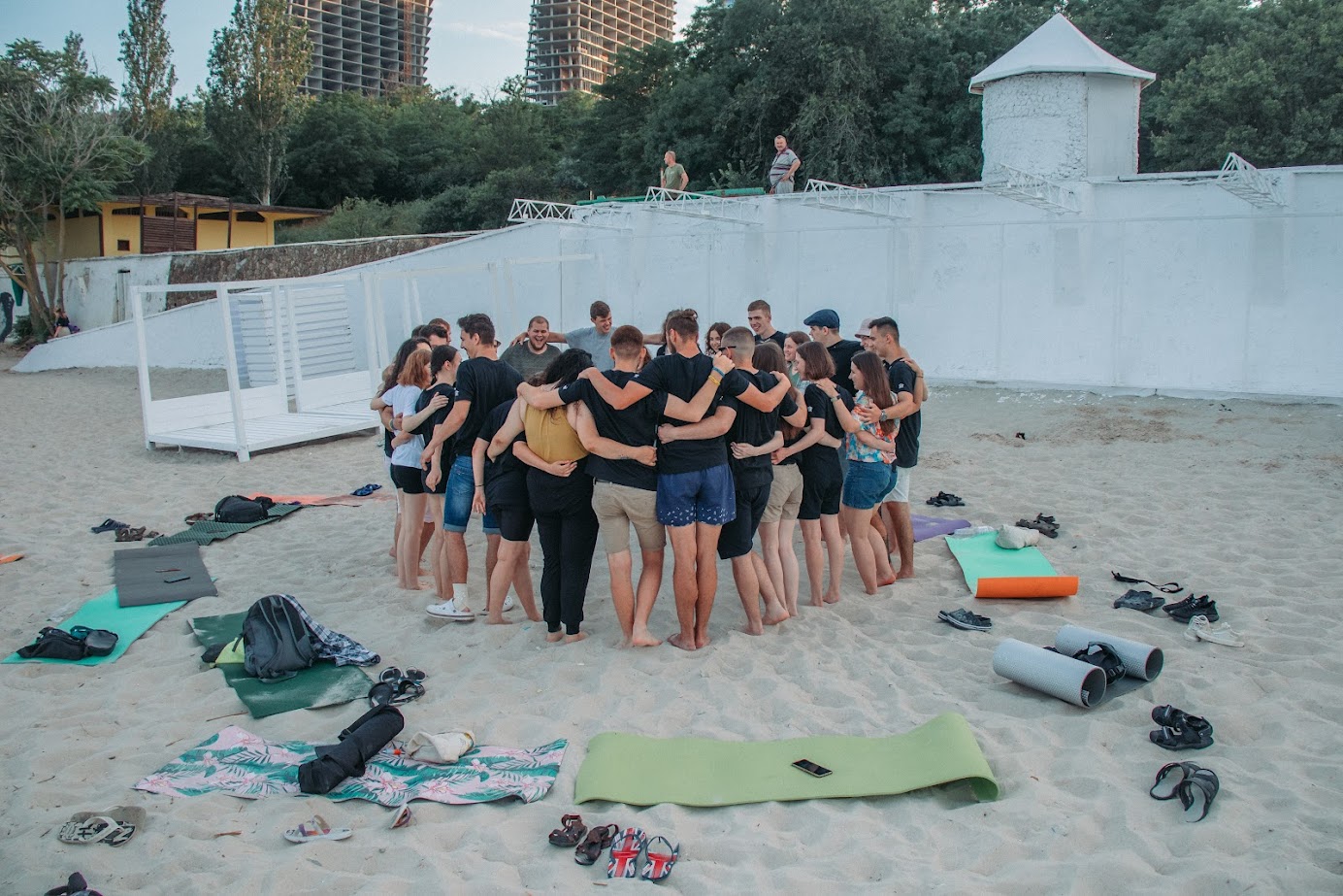Group of young people hugging on a beach