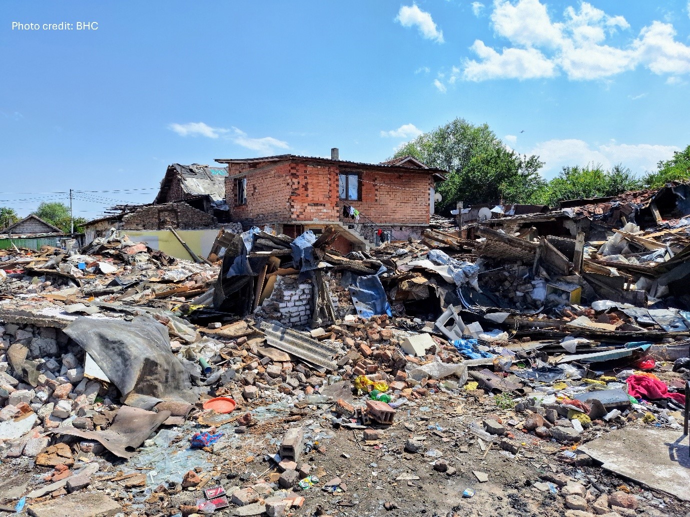 A house in a pile of debris

Description automatically generated