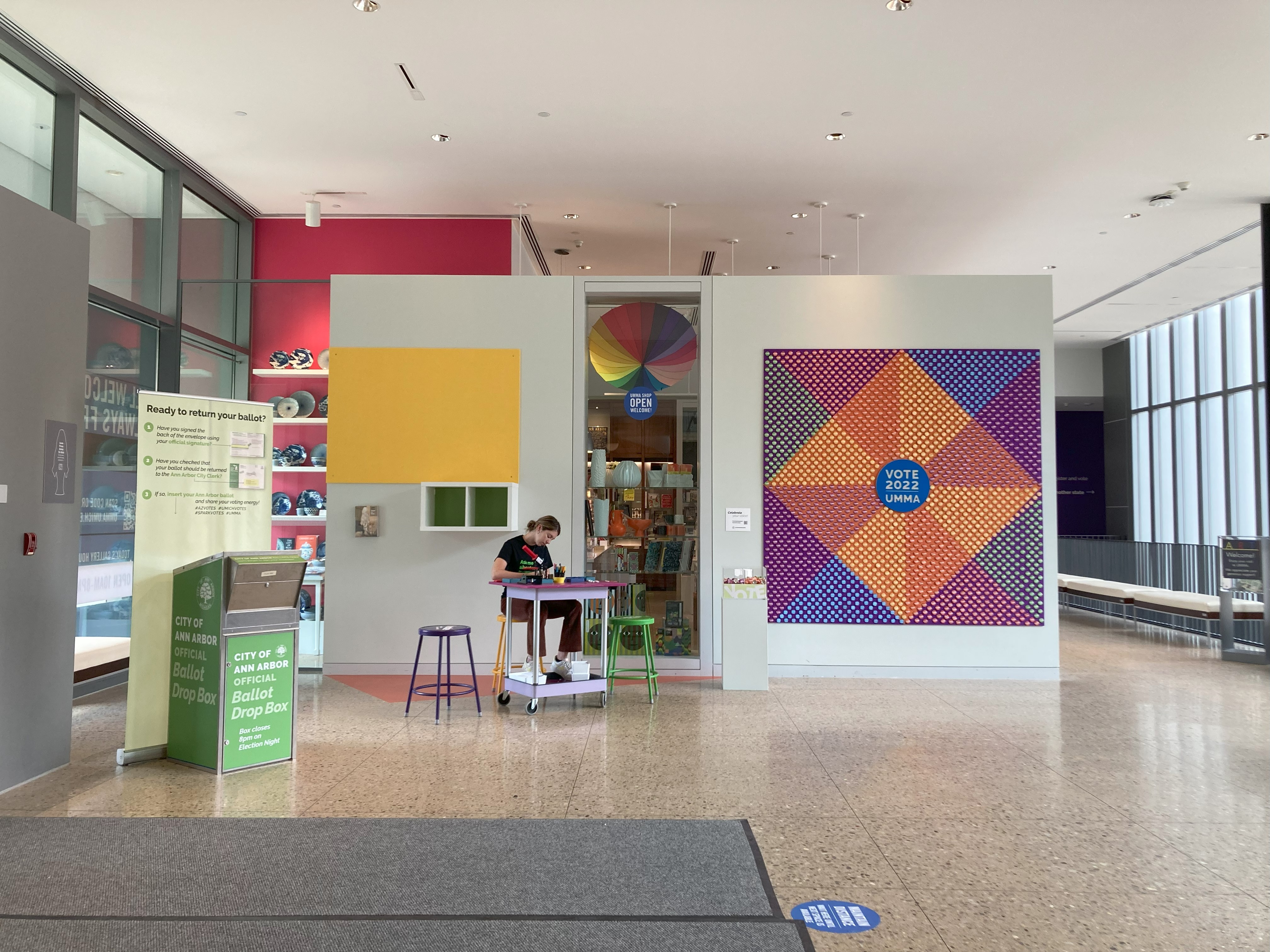 Mural, button making cart, and drop box at UMMA, 2022. Photo Credit: Creative Campus Voting Project