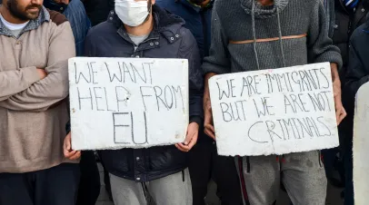 Migrants with signs asking for help from EU