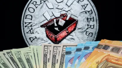 dollars and euros displayed in front of pandora papers symbol