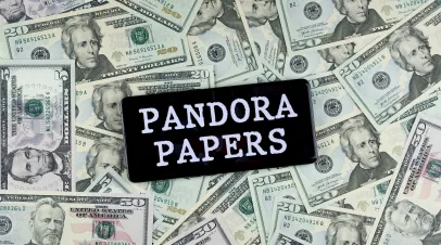 Pandora Papers sign on a pile of money