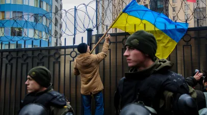 Ukrainian protesters near General Consulate of Russian Federation against aggression of Russia. Protester holding a flag of Ukraine.