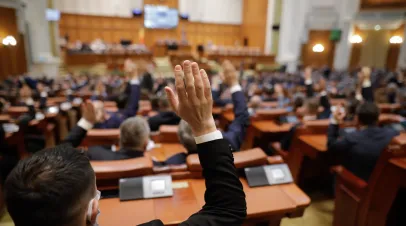Romanian MPs voting by raising their hands.