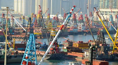Commercial Barges with industrial freight cranes in the South China Sea