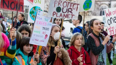 Protestors with banners at a Youth strike for climate march in central London.
