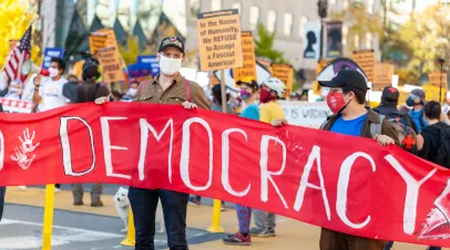  A group of democratic socialists wearing rose handshake face masks are marching near White House to celebrate the defeat of Donald Trump in US elections.