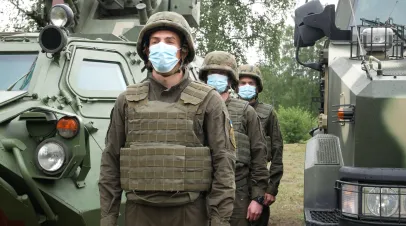 Ukraine Soldiers of the National Guard in body armor near the armored vehicle