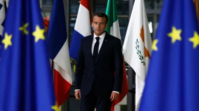 French President Macron in between EU flags