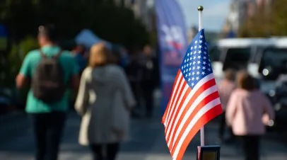 US Flag, out of focus background of people walking. 