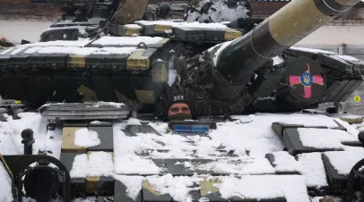 A tanker peeps out of the hatch of a T-64 tank.