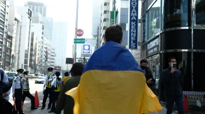 A man draped in the colors of the Ukranian flag at a march in Shibuya, Tokyo 