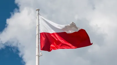 Waving national flag of Poland on a flagpole, national colors of Poland.