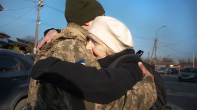 Ukrainian soldier hugging family member