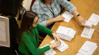 two people counting ballots