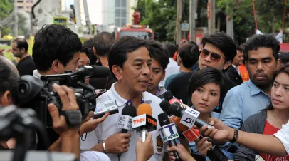 An unidentified local government official gives an interview to journalists