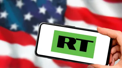 Russia Today screen in front of American flag