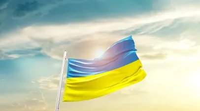 Ukraine national flag waving in beautiful clouds.