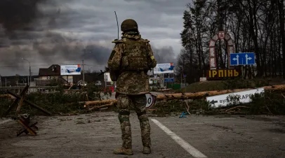 Ukrainian soldier stands on the check point during the evacuation of local people.