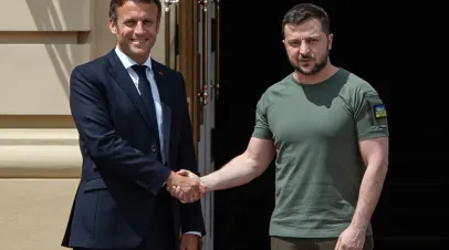 Ukrainian President Volodymyr Zelensky shakes hands with France's President Emmanuel Macron