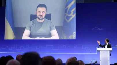 U.K. Prime Minister Rishi Sunak introduces Ukraine's President Volodymyr Zelensky as he appears on the screen at the opening session on the first day of the Ukraine Recovery Conference. HENRY NICHOLLS/WPA POOL/GETTY IMAGES