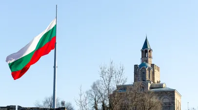 Patriarchal church at Tsarevets fortress, Veliko Tarnovo, Bulgaria and waving flag of Bulgaria