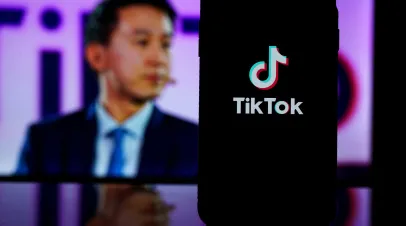 Kaunas, Lithuania - 2023 March 26: TikTok logo on screen and Tik Tok CEO Shou Zi Chew on blurred background. High quality photo