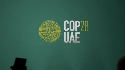 The logo of the COP28 UAE on a green wall. The COP's logo of 2023 color logo.