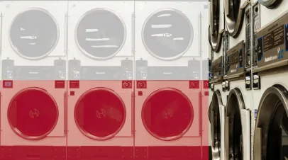 Row of laundry machines, with a Polish flag overlaid