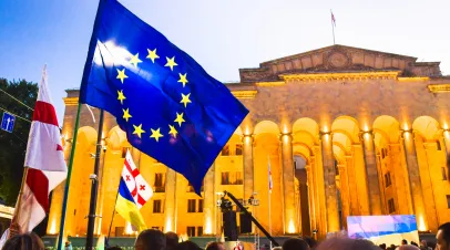 Georgian and EU flags in front of the Georgian Parliament