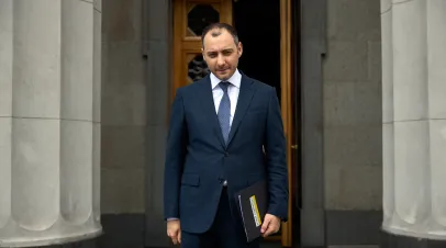 Ukrainian government minister Oleksiy Kubrakov standing in front of columns 