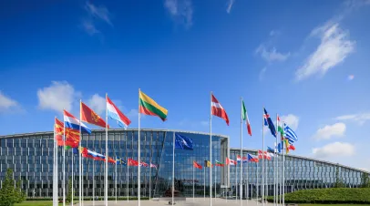 NATO logo flags in front of the headquarters building in Brussels, Belgium.