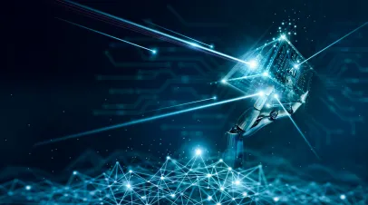 Graphic of a robotic hand holding a cube that has AI on it in glowing blue letters