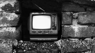 TV sitting inside a niche in a brick house