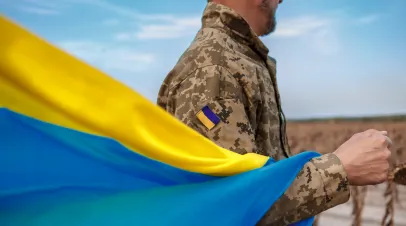 Shutterstock by Pavlovska Yevheniia Ukranian Soldier with flag