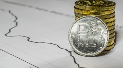 Stack of Russian rubles next to a piece of paper with a graph