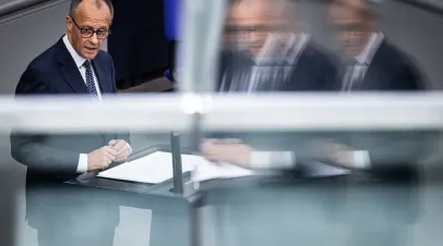 German Chancellor Friedrich Merz standing at a podium