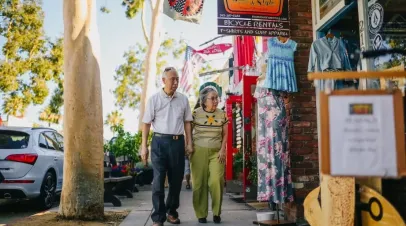 Elderly Asian company walking down the street