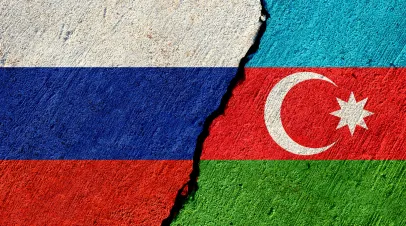 Blocks with flags of Azerbaijan and Russia with a crack in between them