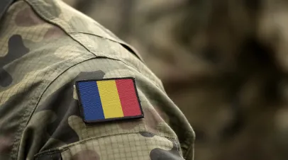 Shoulder of a military jacket with a romanian flag patch