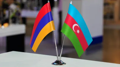 Two small table flags of Azerbaijan and Armenia together at some event or fair, as a symbol of cooperation between the two states. Joint business of Armenia and Azerbaijan