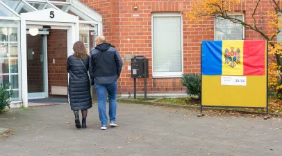 A man and a woman go vote in Moldovan elections
