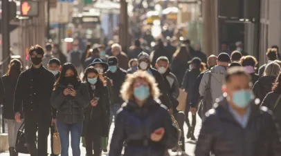 NEW YORK - CIRCA NOVEMBER 2020: Crowd of people walking street wearing masks during covid19 coronavirus pandemic