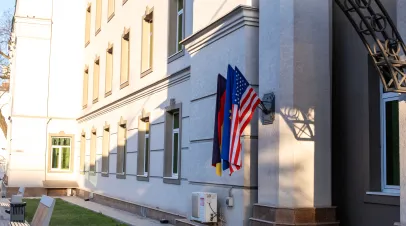 The flag of the United States of America, the EU and Germany on the facade of the building. The concept of partnership relations between countries.