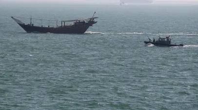  US Navy patrol boat follows a boat that passed near the USS Ponce where U.S. Secretary of Defense Chuck Hagel was taking a tour, on December 6, 2013 in Manama, Bahrain. Secretary Hagel is on a six-day trip to the middle east before returning to Washington. US Secretary of Defense Chuck Hagel toured the Ponce which was recently refitted and converted to a staging base for mine countermeasures helicopters and carries a laser weapons system. 